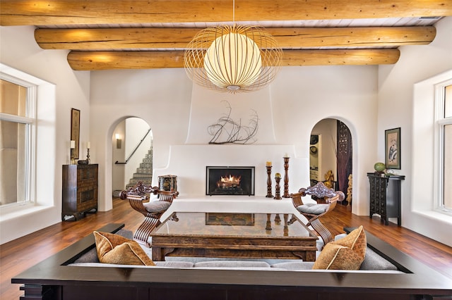 living room featuring beam ceiling, wood ceiling, and hardwood / wood-style flooring