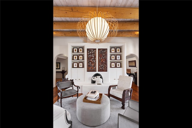 living area with beam ceiling and wood ceiling