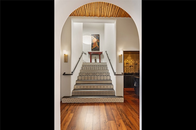 stairs featuring hardwood / wood-style floors