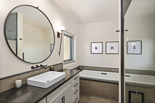 bathroom with independent shower and bath, tile patterned floors, and vanity