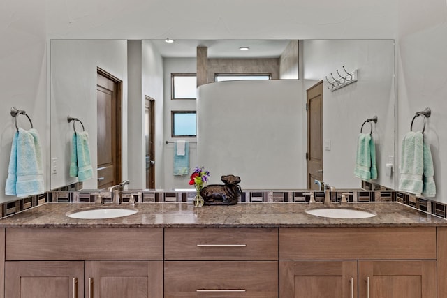 bathroom with a sink and double vanity