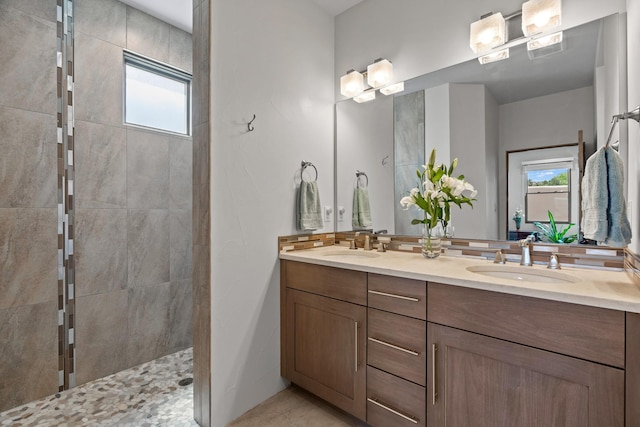 bathroom featuring double vanity, a walk in shower, and a sink