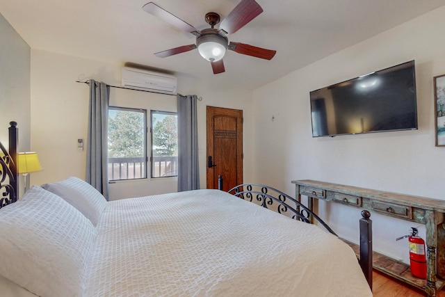 bedroom featuring ceiling fan, hardwood / wood-style floors, and a wall mounted air conditioner