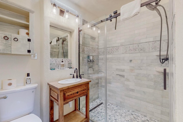 bathroom featuring an enclosed shower, toilet, and vanity