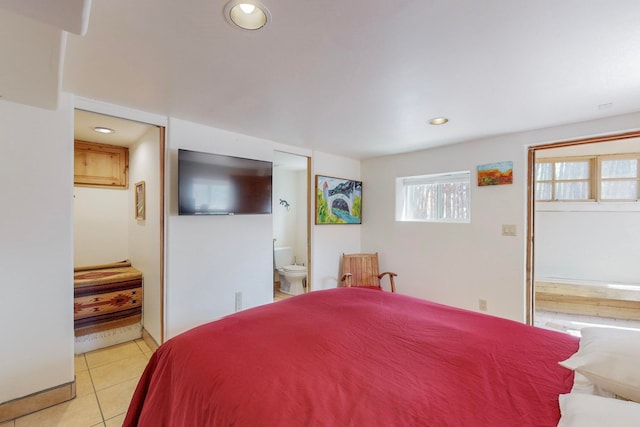 tiled bedroom featuring ensuite bath