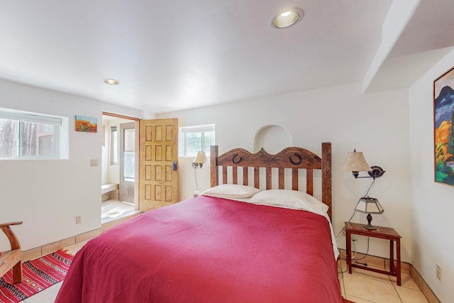 bedroom featuring tile floors and ensuite bathroom