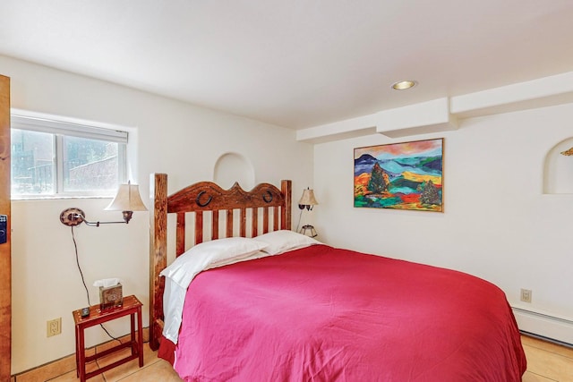 tiled bedroom featuring a baseboard heating unit