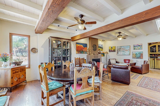 dining room with beamed ceiling, hardwood / wood-style flooring, and ceiling fan