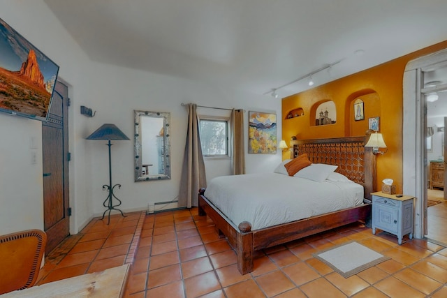 tiled bedroom with a baseboard radiator and rail lighting