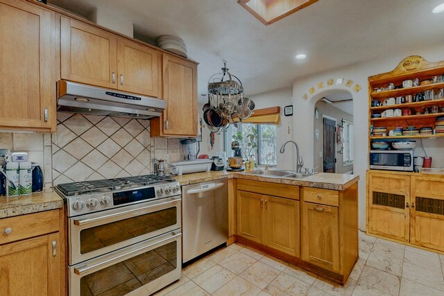 kitchen with appliances with stainless steel finishes, tasteful backsplash, and light tile floors