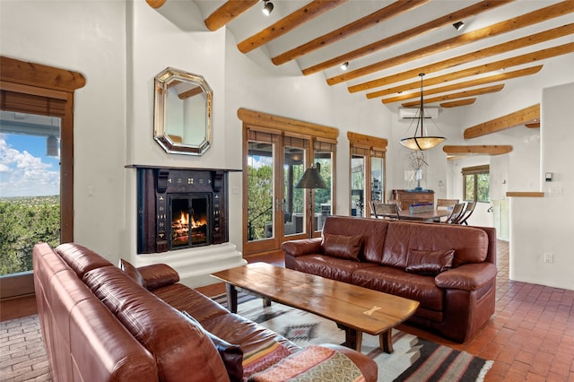 living room featuring a high ceiling, beamed ceiling, and french doors