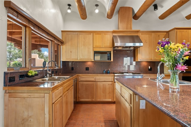 kitchen with tasteful backsplash, black microwave, beam ceiling, sink, and extractor fan