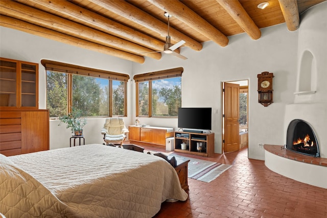 bedroom with ceiling fan, a fireplace, beam ceiling, and wooden ceiling