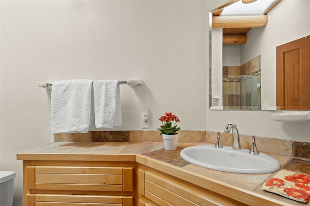 bathroom featuring vanity, a shower, and toilet