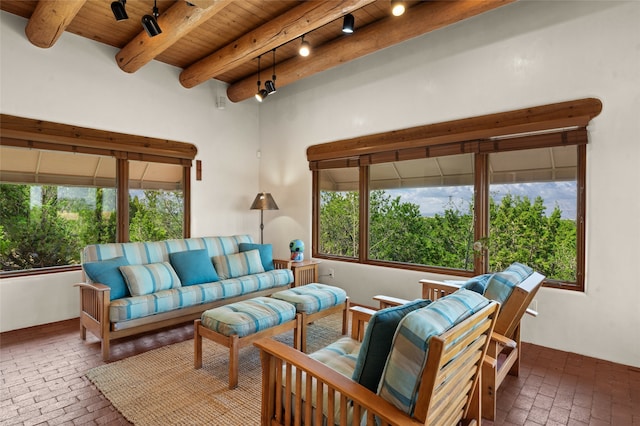 living room with wood ceiling, beamed ceiling, and plenty of natural light