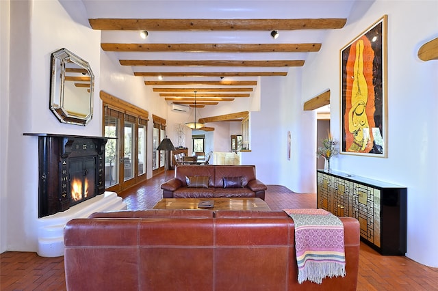 living room with french doors and beam ceiling