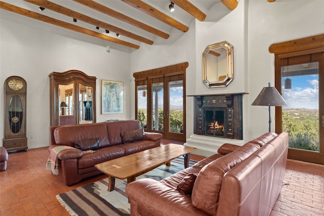 living room with beamed ceiling and a towering ceiling