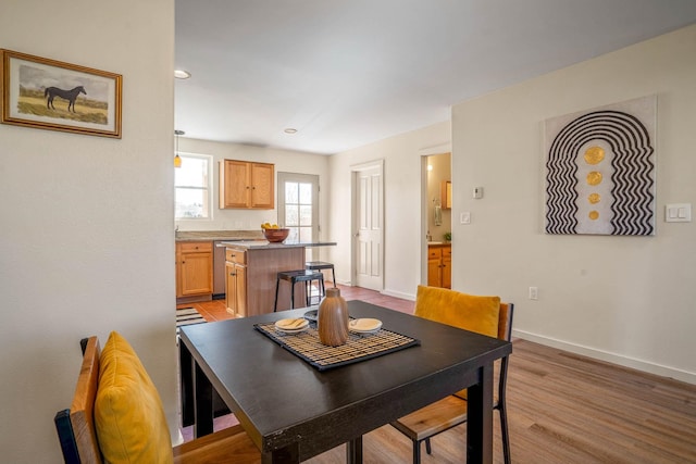 dining room featuring baseboards and light wood-style floors