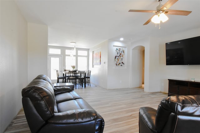 living room featuring ceiling fan and light hardwood / wood-style flooring