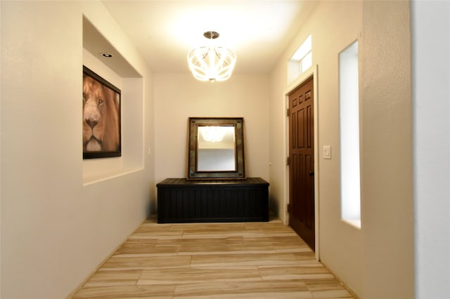 hallway featuring a notable chandelier