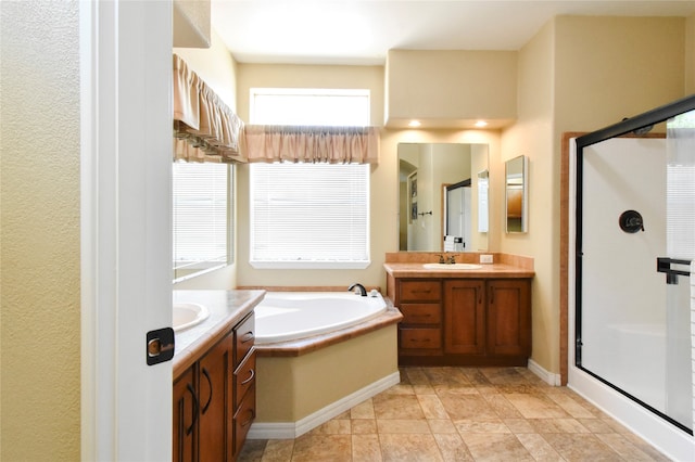 bathroom with tile flooring, independent shower and bath, and vanity