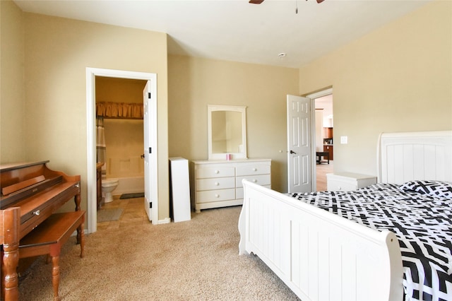 bedroom with light colored carpet, ensuite bathroom, and ceiling fan