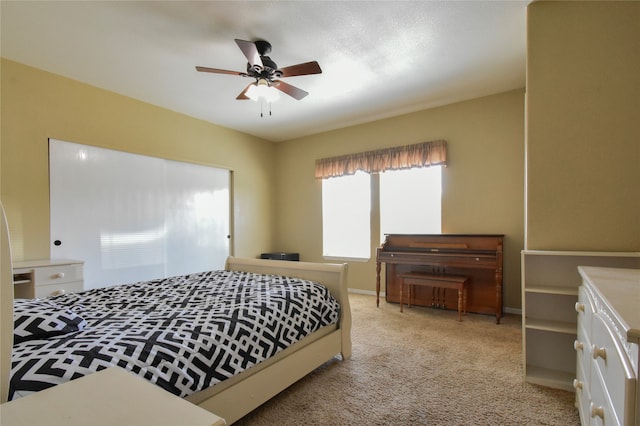 bedroom featuring light carpet and ceiling fan