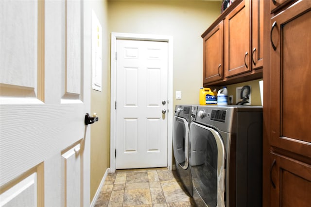 laundry area with cabinets, light tile flooring, and separate washer and dryer