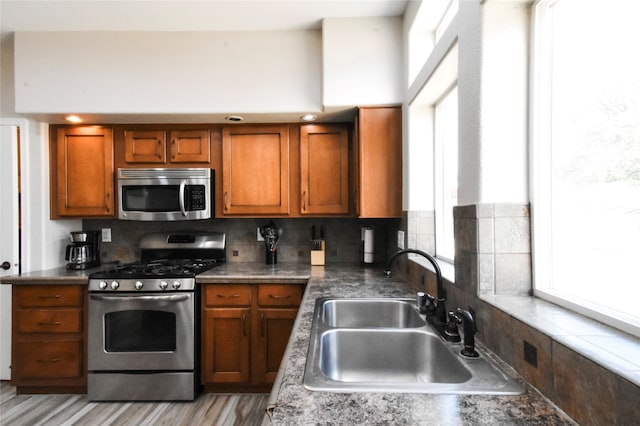 kitchen with sink, backsplash, and range with gas stovetop