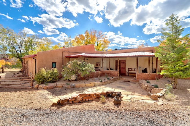 back of property featuring a patio area