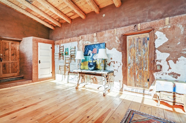 miscellaneous room featuring vaulted ceiling with beams, wood ceiling, and hardwood / wood-style flooring