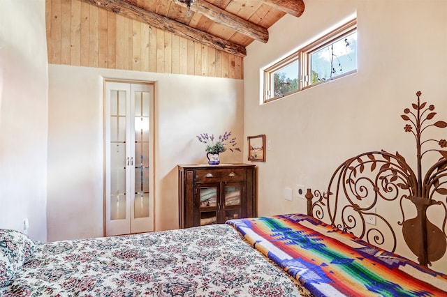 bedroom with a closet, wood ceiling, high vaulted ceiling, and beamed ceiling