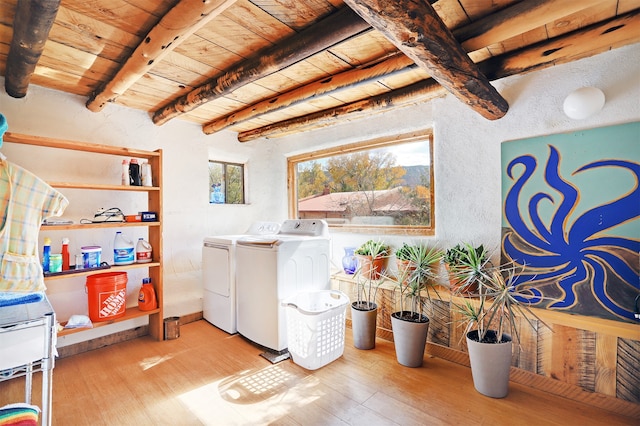 laundry room with washer and clothes dryer, hardwood / wood-style flooring, and wooden ceiling