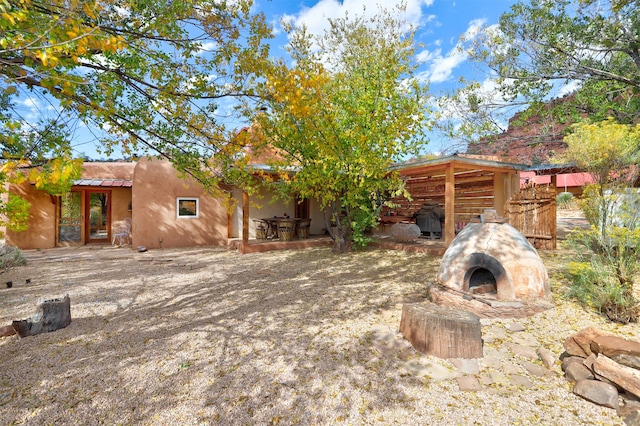 view of yard featuring a patio area and an outdoor stone fireplace