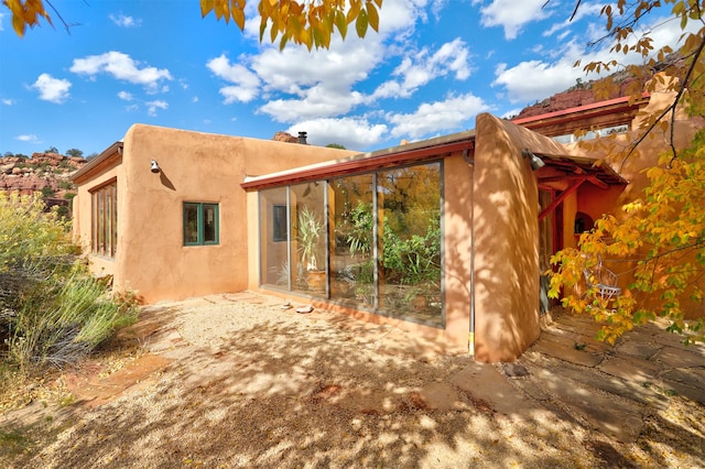 back of house with a patio