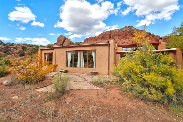 back of house featuring a patio and a mountain view