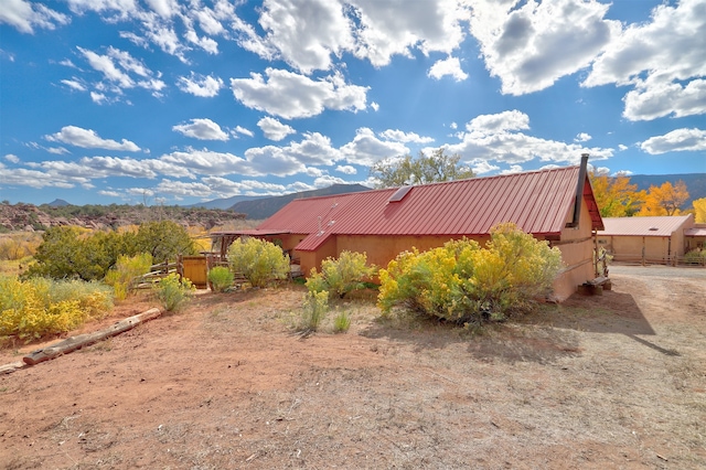 view of side of home featuring a mountain view