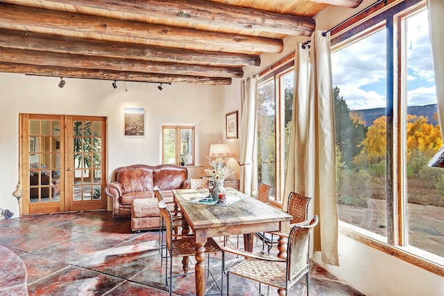 sunroom with beamed ceiling, french doors, a mountain view, and wooden ceiling