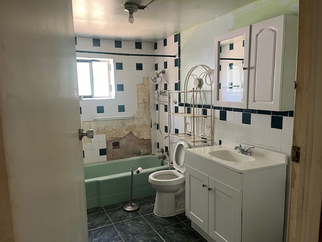 full bathroom with backsplash, toilet, tile floors, tiled shower / bath, and vanity