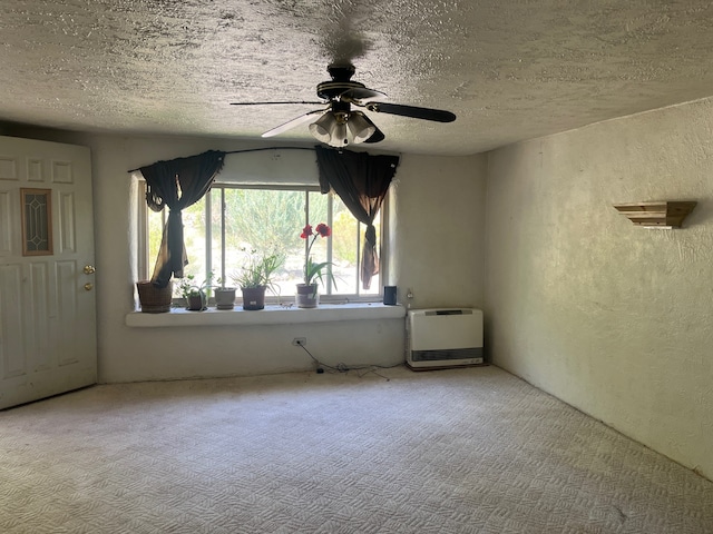 carpeted empty room with a textured ceiling and ceiling fan