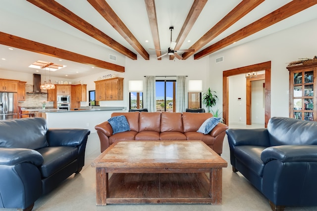 living room with beamed ceiling and ceiling fan