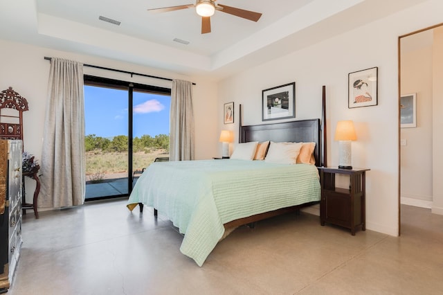 bedroom featuring access to outside, ceiling fan, and a tray ceiling