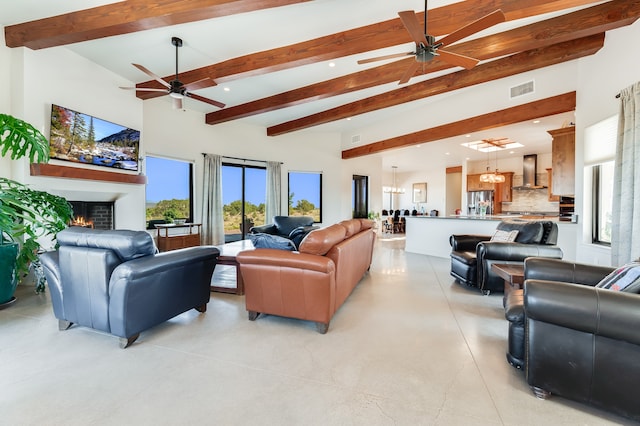 living room with ceiling fan and beamed ceiling