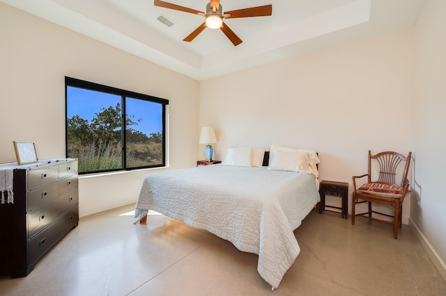 bedroom with ceiling fan and a raised ceiling