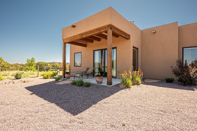 back of house with a patio area