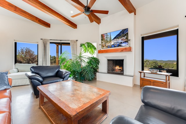 living room featuring beamed ceiling and ceiling fan