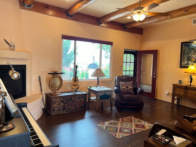 living room with ceiling fan, beam ceiling, and dark hardwood / wood-style flooring