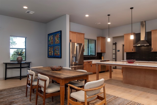 dining area featuring sink and light wood-type flooring