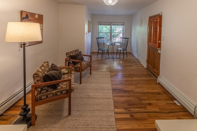 corridor with dark hardwood / wood-style flooring and baseboard heating