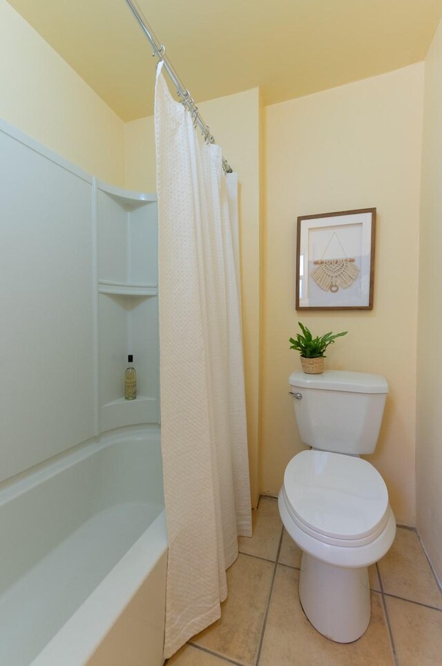 bathroom with toilet, tile patterned floors, and an enclosed shower